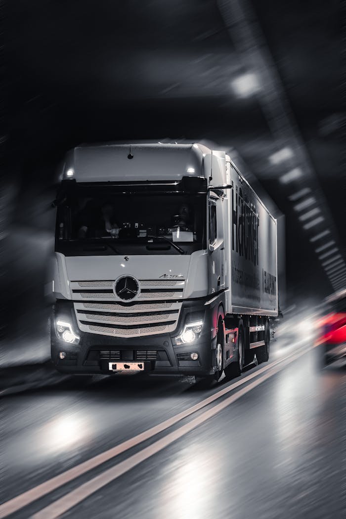 gallery-5 Mercedes-Benz Actros truck speeding through a city tunnel, capturing urban motion and energy.